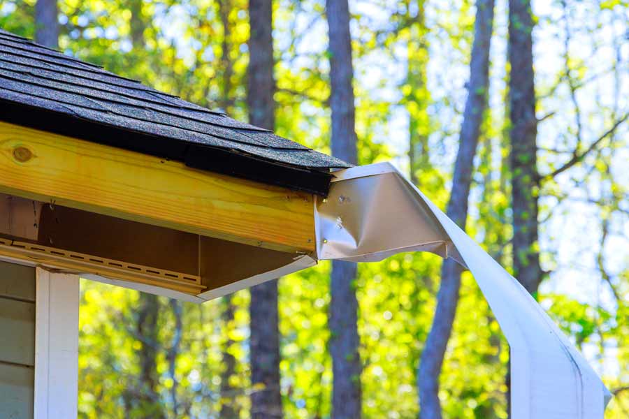 House gutter system against forest background.