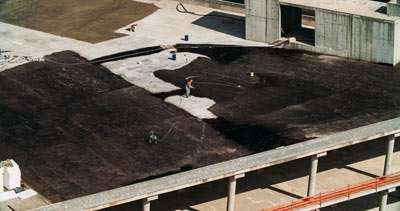 Construction site with workers and building foundation.