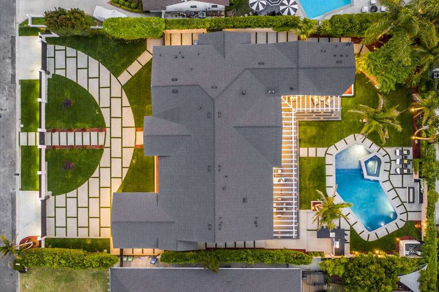 Aerial view of residential backyard with pool.